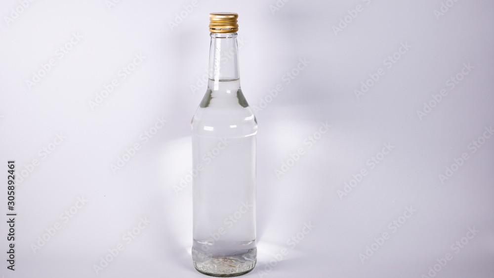 Fototapeta premium Bottle with a clear liquid, vodka on a white background