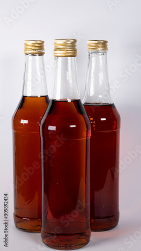 Bottles with cognac, whiskey on a white background