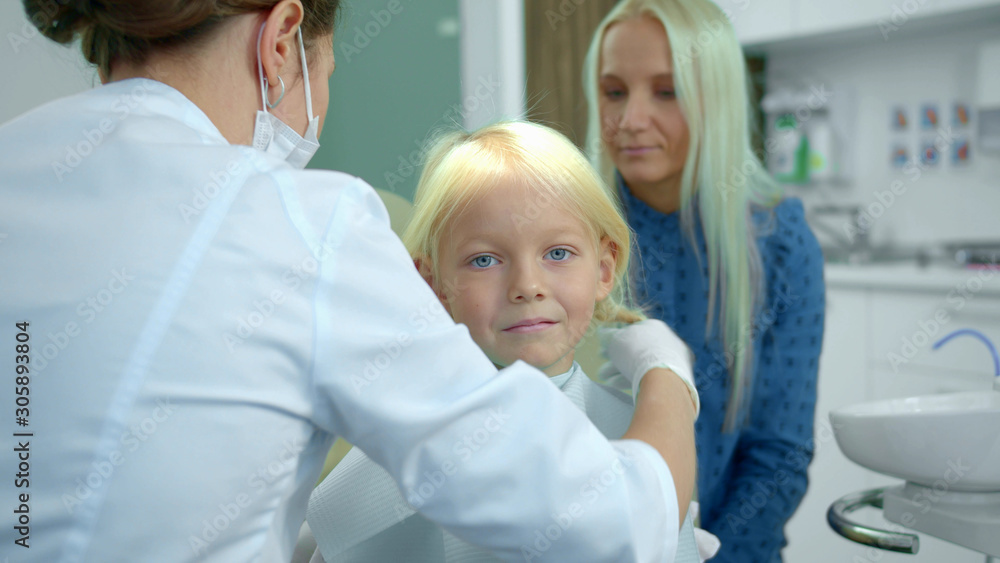 Dentist fastens a diaper on a girl and takes a medical drill Dentist fastens a diaper on a girl and takes a medical drill