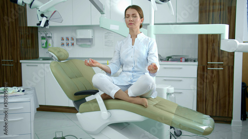 Doctor meditates on a chair that rises above