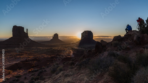 Two photographers capturing the sunrise over Monument Valley, AZ