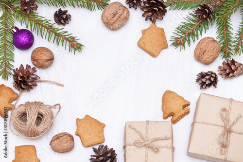 Christmas composition. Xmas gingerbread cookies, cookies in shape of houses, fir branches, gifts on white background. New year 2020. Flat lay, top view, copy space.