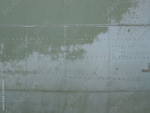 Canvas Print Old green metal surface of the aircraft fuselage with rivets