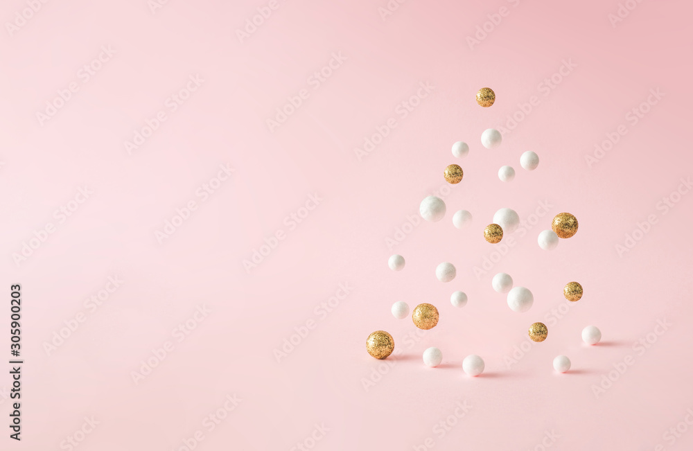 Christmas composition. Pink Christmas tree, with decoration on pink background. Happy holidays. new year minimal concept.