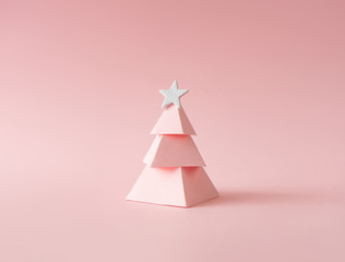 Christmas composition. Pink Christmas tree on pink background. Happy holidays. new year minimal concept.