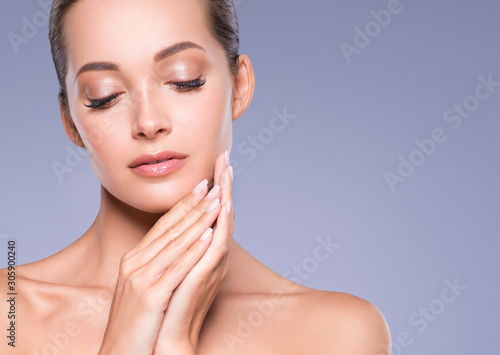 Beautiful woman face eyes close hand manicure nails natural make up healthy skin close up beauty eyes