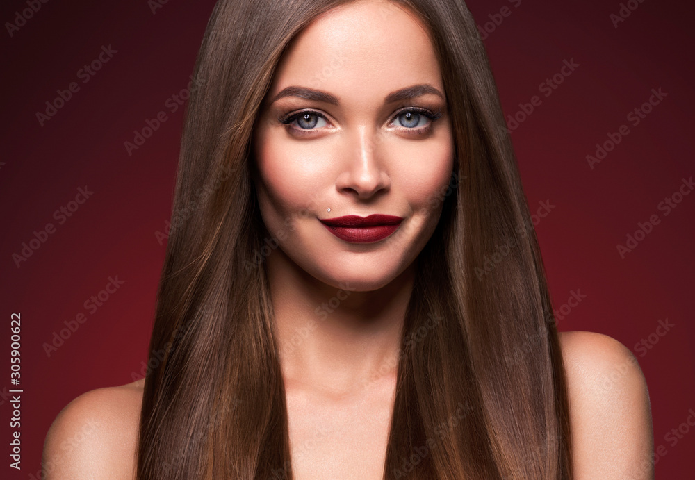 Fototapeta premium Beauty face female red lops long smooth hair red dark background