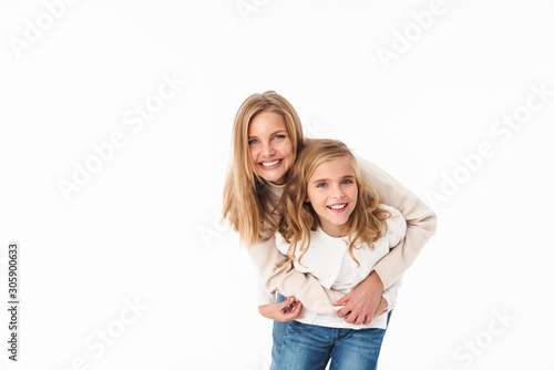 Image of pretty caucasian mother and little daughter hugging together