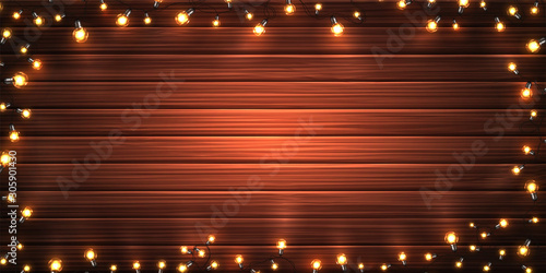 Christmas garland of lights on wooden background