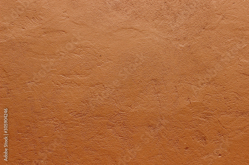 Dark terracotta plaster rough wall texture background photo