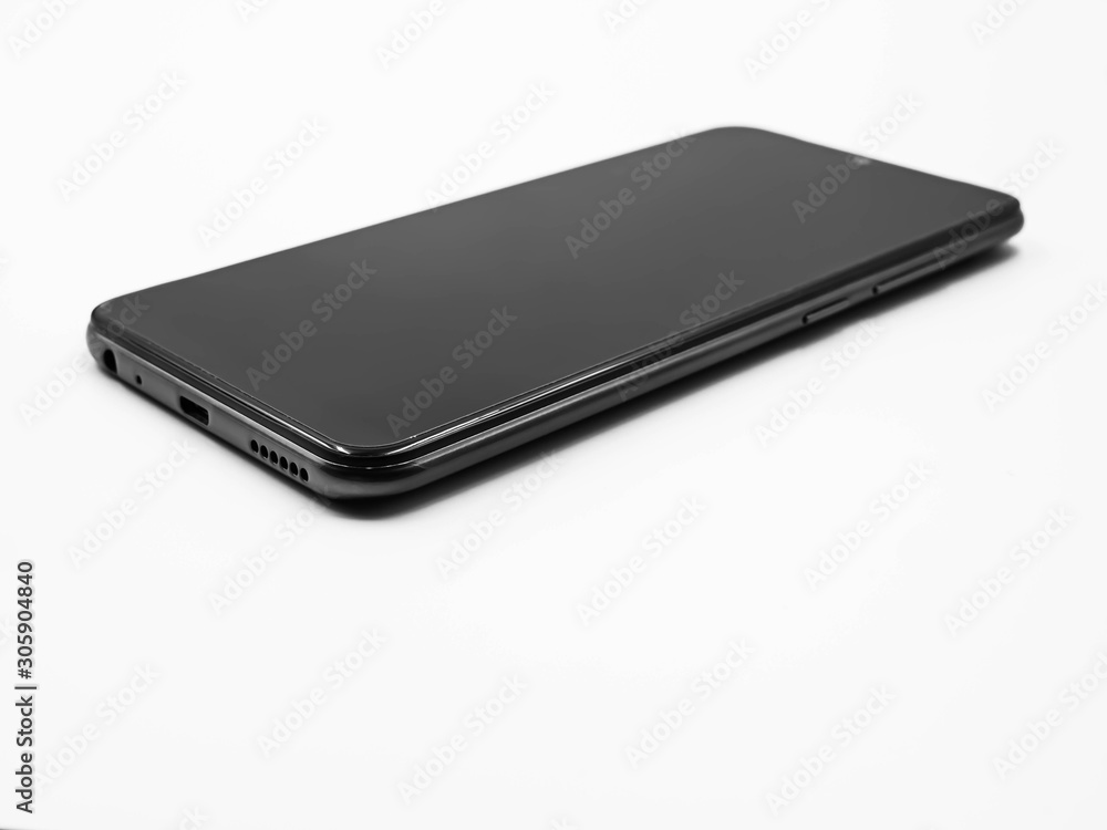 Black and white tone and closeup of smartphone on gray background. Black and white tone and closeup of smartphone on gray background.