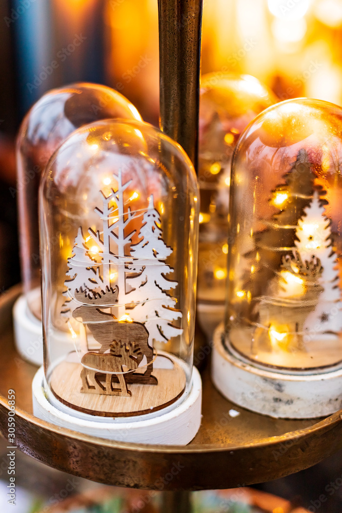 Christmas decoration: Wooden figures of moose in forest in a glass dome