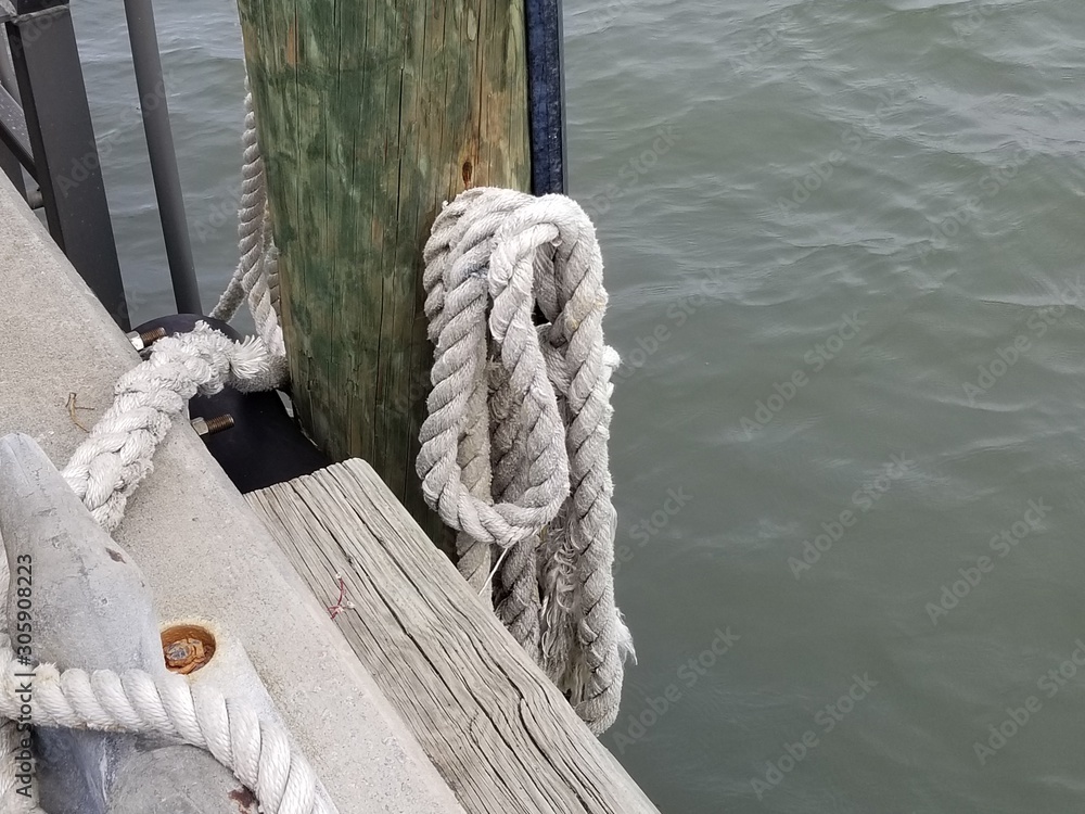 Fototapeta premium rope, boat, knot, ship, sea, sailing, nautical, ropes, water, blue, ocean, line, old, sailboat, marine, wood, tied, yacht, harbor, mooring, sail, rigging, vessel, dock, equipment