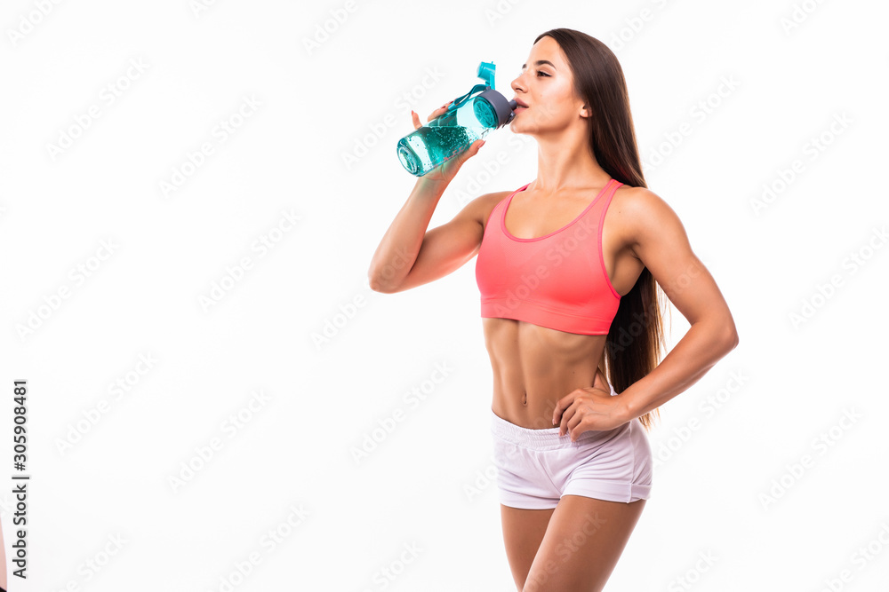 Young happy smiling woman in sportswear drinking water, over white background Young happy smiling woman in sportswear drinking water, over white background