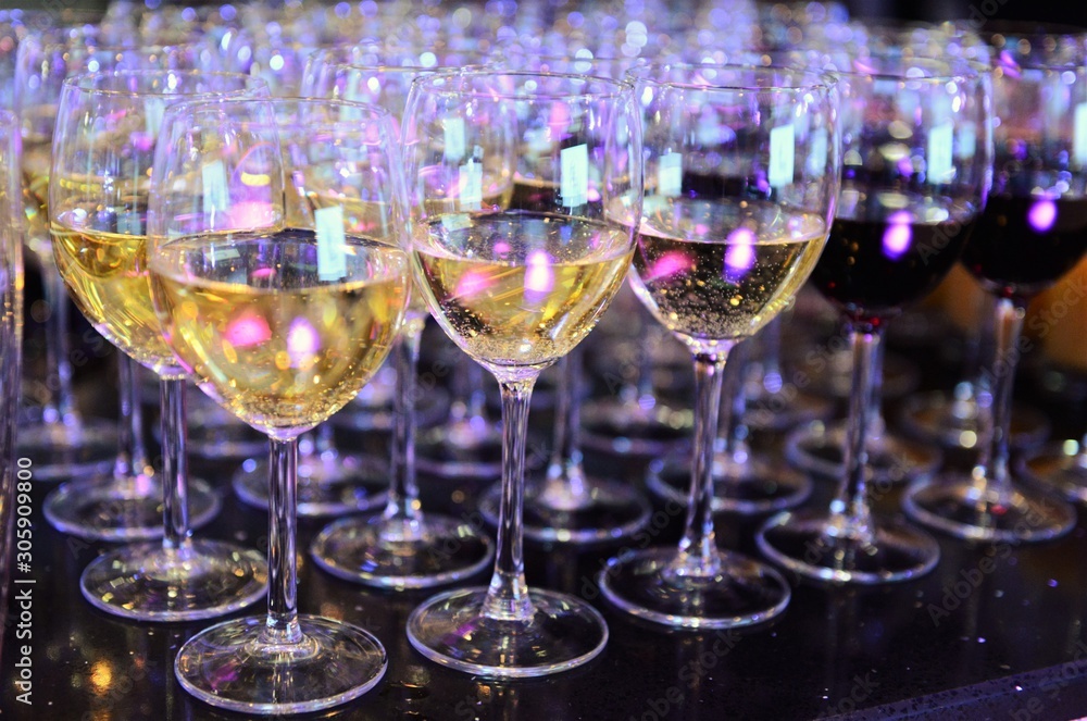 Rows of full champagne, sparkling wine and red wine glasses. Dining, drink. Catering service concept. Rows of full champagne, sparkling wine and red wine glasses. Dining, drink. Catering service concept.