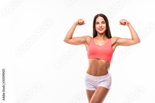 Portrait of a beautiful fitness woman showing her biceps isolated on white background