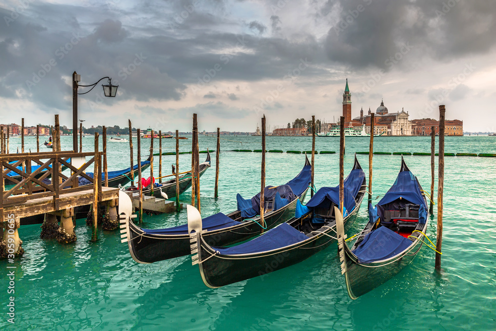 Gondolas in the harbor of Venice with San Giorgio Maggiore island, Italy