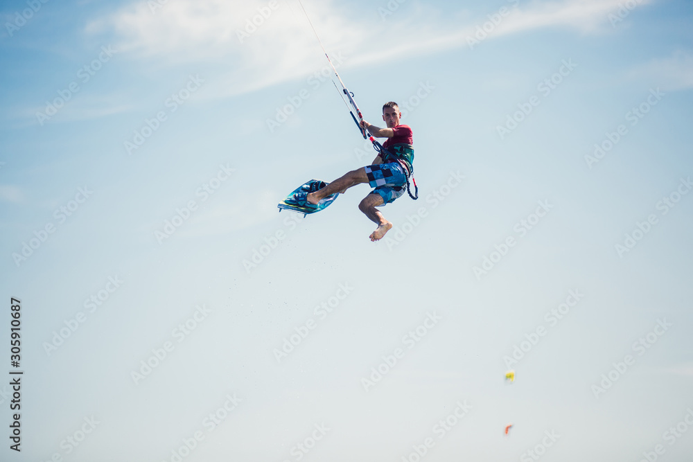 Professional kiter makes the difficult trick on a beautiful background. Kitesurfing Kiteboarding action photos man among waves quickly goes Professional kiter makes the difficult trick on a beautiful background. Kitesurfing Kiteboarding action photos man among waves quickly goes