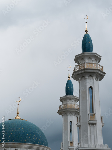 Islam is a religion. Towers of a mosque with a blue roof. 