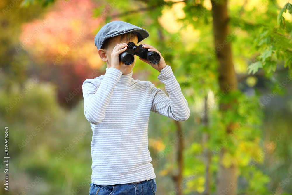 portrait of a little boy looking through the binoculars