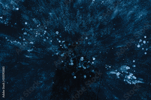  ice texture with frozen air bubbles. winter dark background