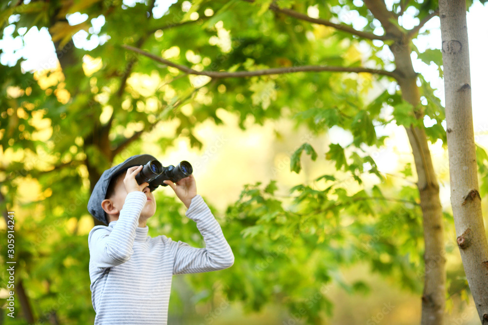 Boy exploring looking through binoculars Boy exploring looking through binoculars