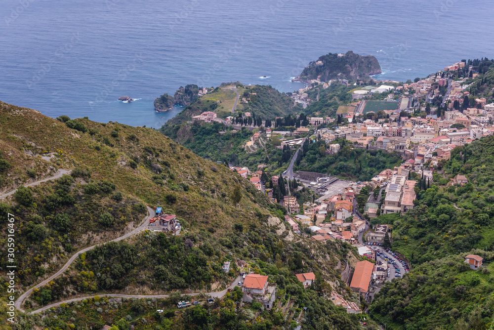 Hairpin road on a green mountain seen from Castelmola, small town on Sicily Island, Italy - Taormina city on background