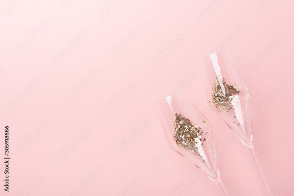 Christmas flat lay. Champagne glasses and gold decoration on pink background - Image Christmas flat lay. Champagne glasses and gold decoration on pink background - Image