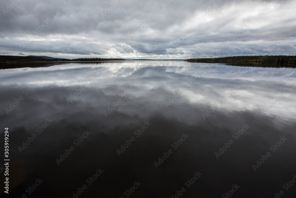 Clouds reflection in Muonio Lake, Lapland, Finland