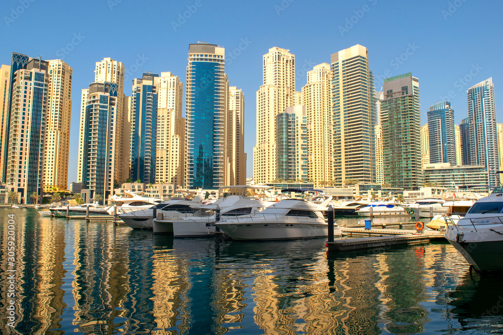 Dubai Marina district with beautiful buildings and yachts. Dubai Marina yachts parking 