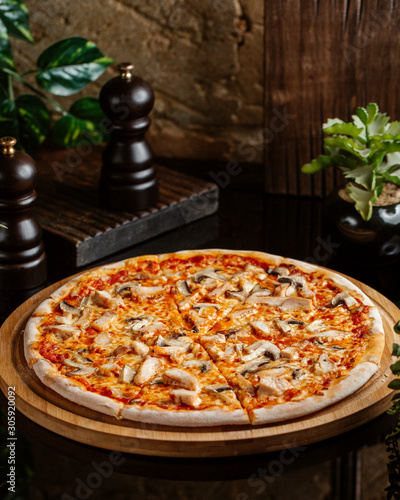 chicken pizza with mushroom, cheese and tomato sauce