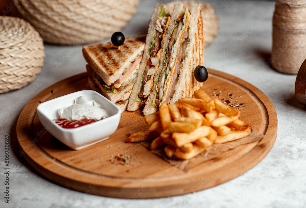 club sandwich served with french fries, mayonnaise and ketchup