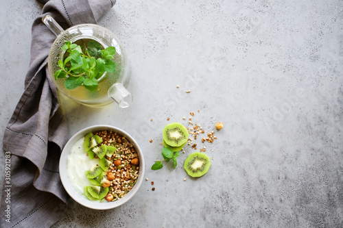 Buckwheat granola with yogurt and kiwi. Nutritious healthy breakfast