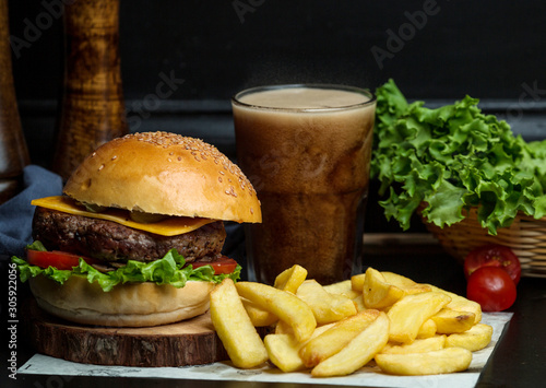 beef burger with cheese  lettuce  tomato served with fries and coke