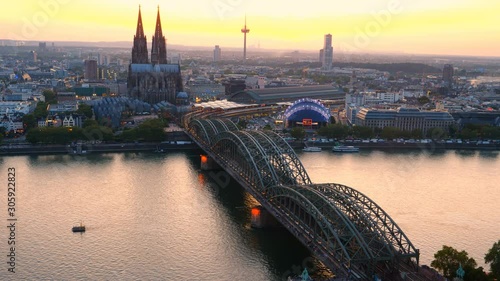 Aerial panorama of the Hohenzollern bridge over Rhine riverat sunset. Beautiful cityscape of Cologne, Germany  with cathedral at dusk. photo