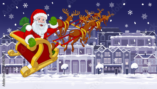 Christmas night street scene with Santa Claus in his Christmas sleigh with reindeer flying over Victorian style houses, shops and other buildings in the snow.