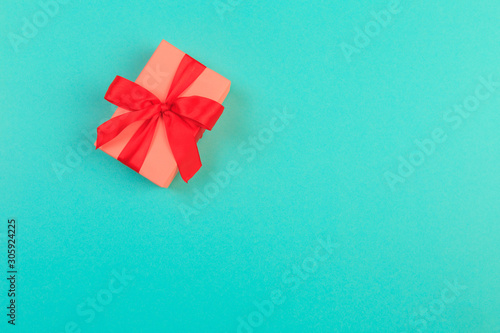 Gift box with ribbon and bow on color background and space for text. Top view - Image