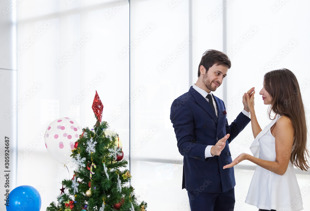 The romantic couple dance after back from work with happiness to celebrate the special festival, New Year, Christmas, Valentine, white tone background. The romantic couple dance after back from work with happiness to celebrate the special festival, New Year, Christmas, Valentine, white tone background.