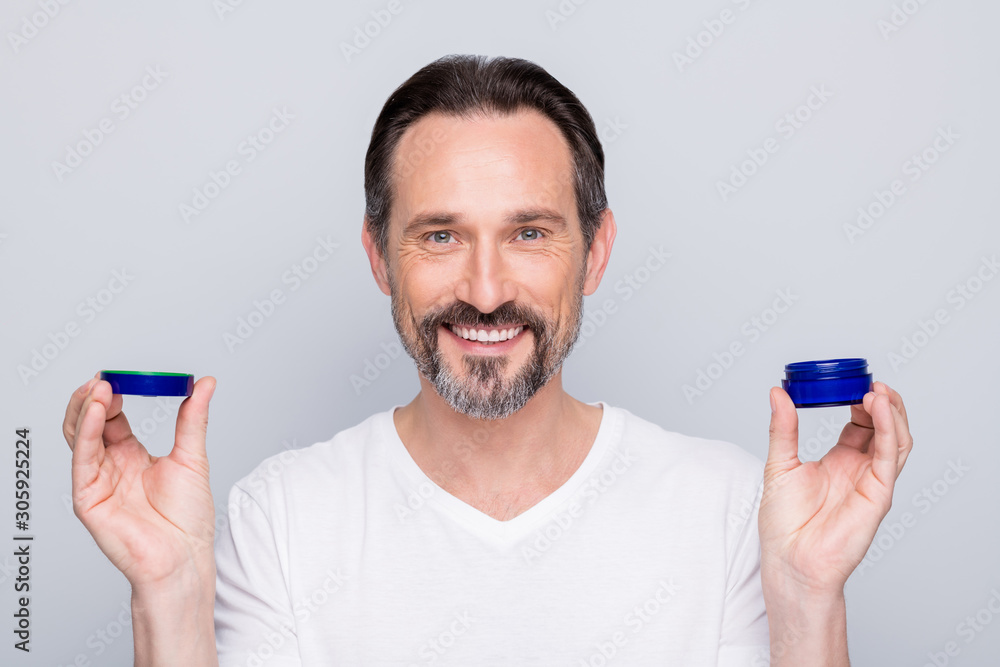 Closeup photo of mature macho guy holding new hair styling product hands  advising cool results showing own hairstyle wear white t-shirt isolated  grey color background Stock Photo | Adobe Stock