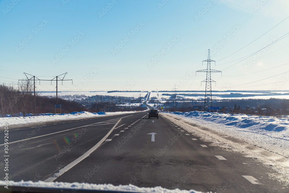 Winter road against a clear blue sky