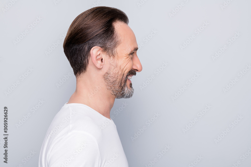 Closeup profile photo of handsome aged man good mood beaming smile looking mirror enjoy mature wrinkles appearance wear white t-shirt isolated grey color background Closeup profile photo of handsome aged man good mood beaming smile looking mirror enjoy mature wrinkles appearance wear white t-shirt isolated grey color background