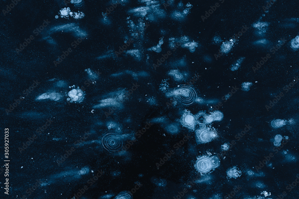  ice texture with frozen air bubbles. winter dark background