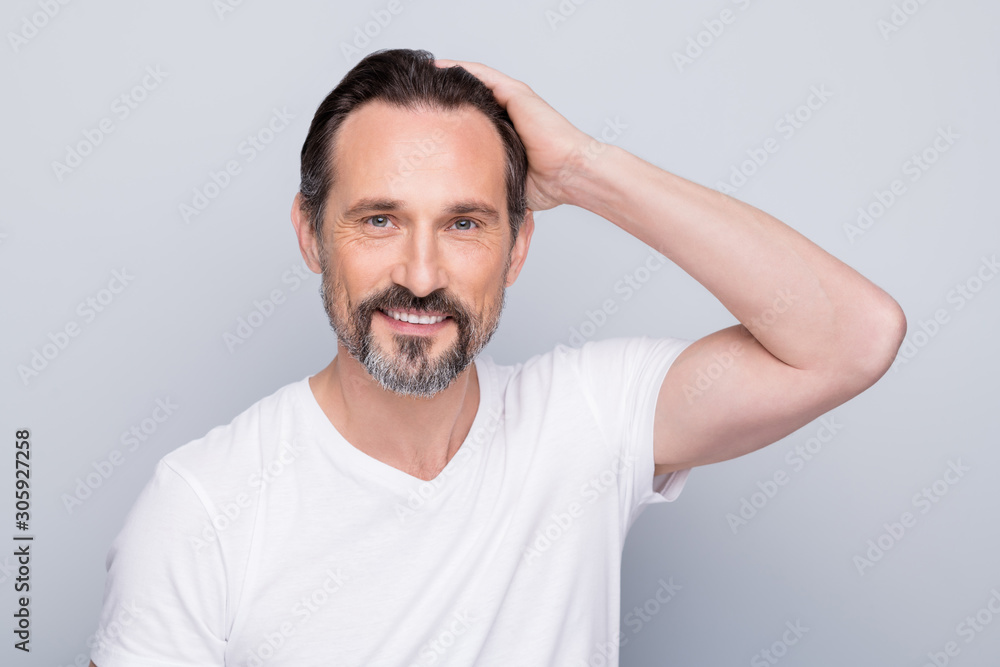 Closeup photo of handsome positive aged man looking mirror hands checking hairstyle after using new hair shampoo conditioner wear white t-shirt isolated grey color background Closeup photo of handsome positive aged man looking mirror hands checking hairstyle after using new hair shampoo conditioner wear white t-shirt isolated grey color background