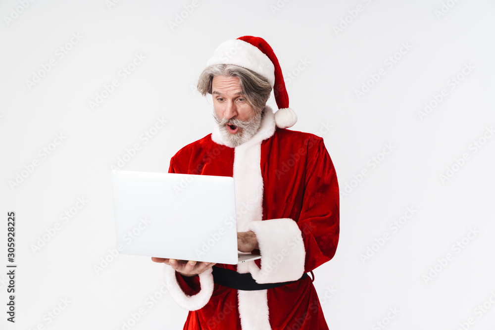 Portrait of surprised old man holding and using laptop Portrait of surprised old man holding and using laptop