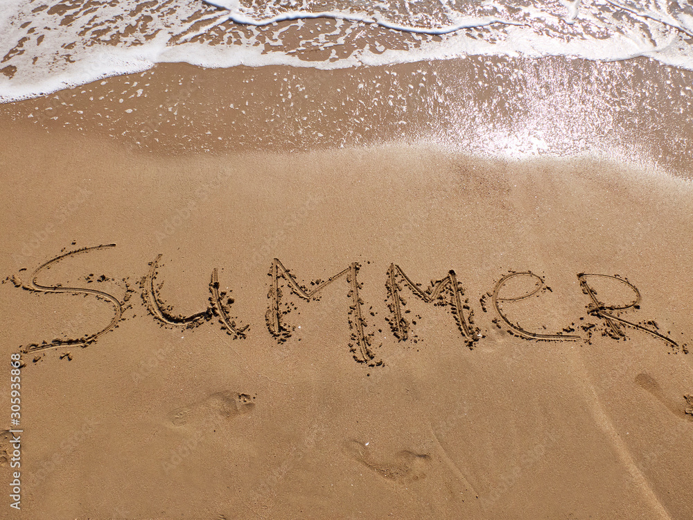 Fototapeta premium Inscription Summer and footprints on the sandy beach