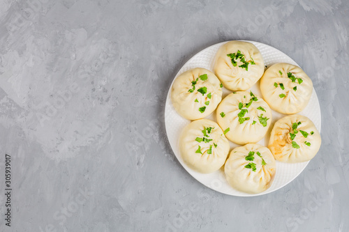 Close up of Chinese steamed dumplings on gray concrete background. Flat lay, top view, overhead, mockup, template. Asian food concept. Traditional food for Chinese New Year celebration