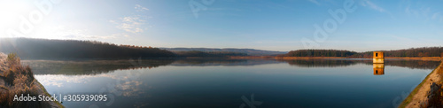 colorful panorama of autumn lake on a bright sunny day