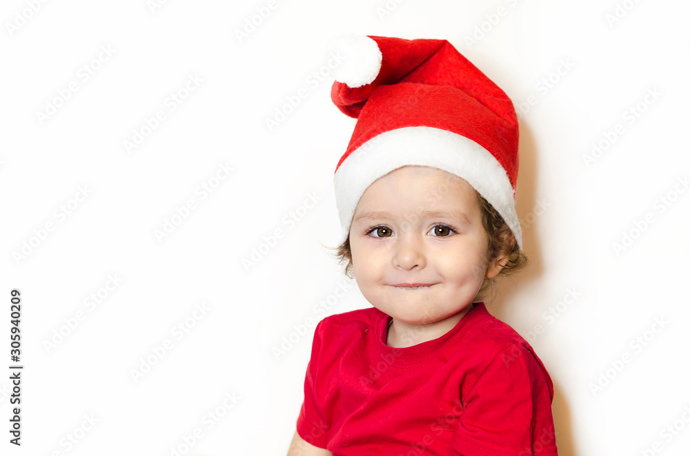 Portrait little happy girl in festive clothes, santa claus hat. cute child in Christmas clothes is waiting and rejoicing in the New Year miracle. baby in red dress isolated on white. soft focus
