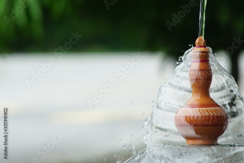 Water pour on the Traditional Malay hand made Clay pottery arts for water storage container or Labu Sayong or Labu Sayung photo