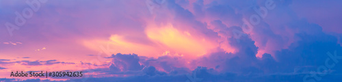 Fantasy colorful background, Gold sunlight on blue sky and moving purple cloud before sunset